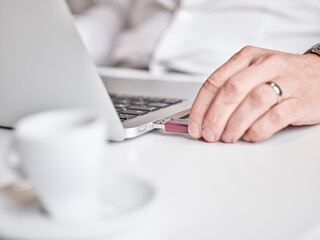 Close-up of man connecting usb stick to laptop