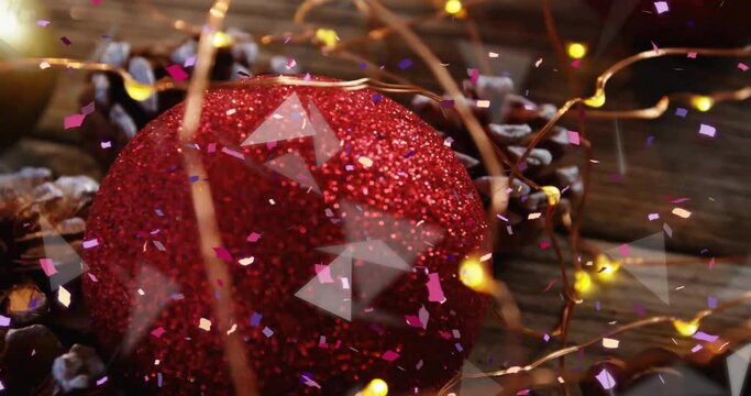Animation of spots of light over christmas red bauble and fairy lights decorations