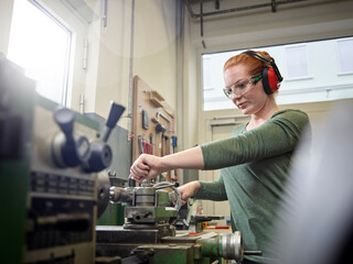 Woman working at a lathe