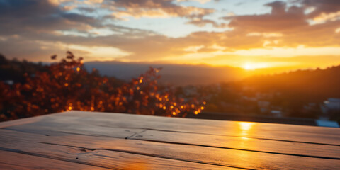 A wooden table against the background of mountains, sunrise and blue sky. The photo is of high quality.