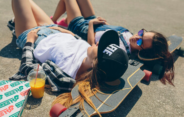 Two young women with longboards enjoying summer - Powered by Adobe