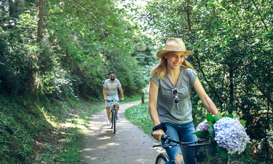 Couple riding bicycle in a forest