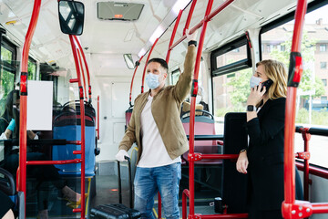 Passengers wearing protective masks in public bus, Spain