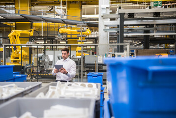 Man using tablet in factory shop floor