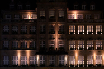 Exterior facade of a building illuminated by a street light at night in the center of Munich City, Germany