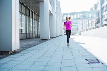 Young woman running in the city