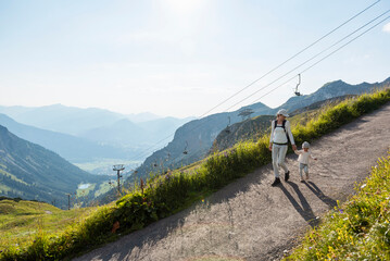 Germany, Bavaria, Oberstdorf, mother and little daughter on a hiking trip in the mountains