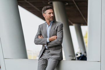 Portrait of confident businessman outdoors looking sideways