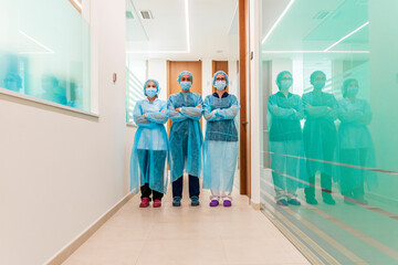 Female doctor and nurses in corridor at dentist's clinic
