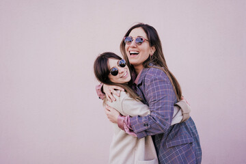 Portrait of two happy young women hugging each other