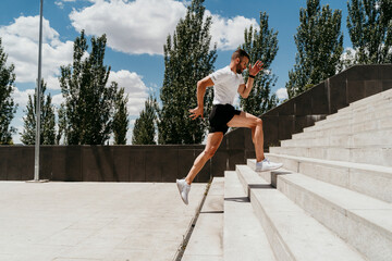Male athlete running up stairs