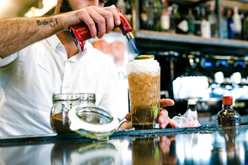 Close-up of barkeeper preparing a cocktail