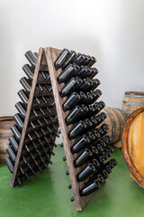 Wooden rack with empty wine bottles without labels
