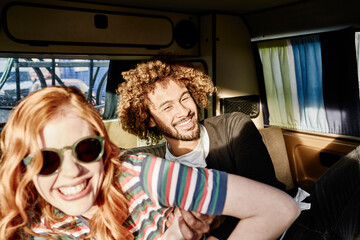 Happy young couple in a van