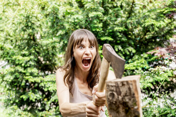 Screaming woman chopping wood
