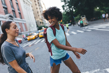USA, New York City, two friends crossing the street