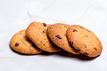 Homemade cookies with chocolate and raisins. White background