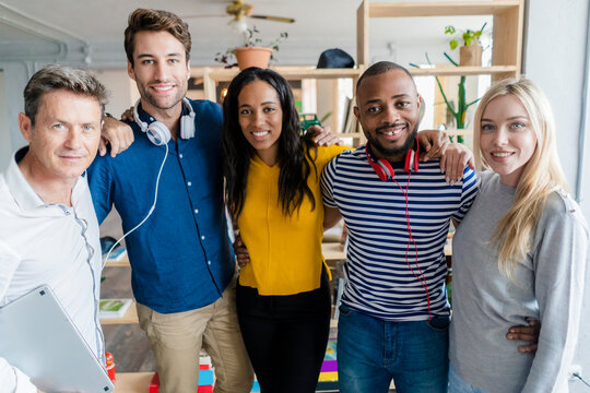 Portrait of confident business team standing in loft office