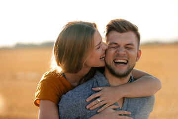 Happy playful young couple in rural landscape - Powered by Adobe