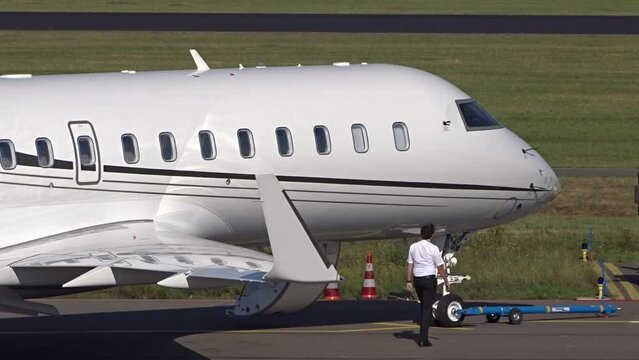 Corporate Jet with PIlot walking next to Aircraft at regional airport (white   unmarked   Business jet  private jet   executive jet)