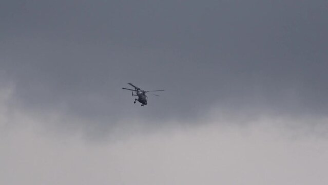 Advanced Military Helicopter Flying in the distance at air base