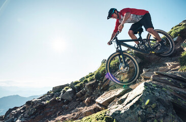 Mountainbiker mountain biking against the sun in Grisons, Switzerland