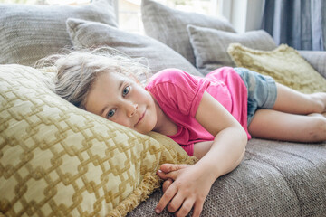 Portrait of girl lying on couch