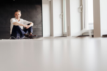 Businessman in office sitting on the floor