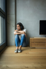 Relaxed woman listening to music at home