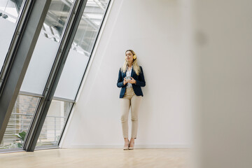 Young businesswoman in office having a break