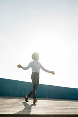 Man dancing at backlight