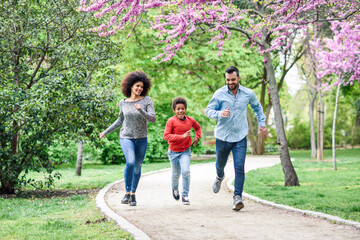 Happy family running and playing in a park