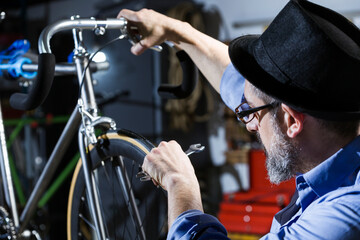 Man working on bicycle in workshop