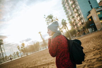 Spain, Barcelona, young woman on the beach in winter