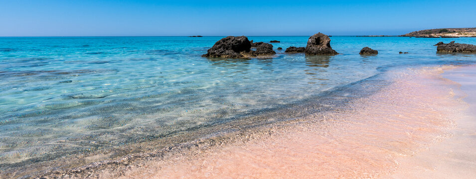 Beautiful view of Elafonisi Beach, Chania. The amazing pink beach of Crete. Elafonisi island is like paradise on earth with wonderful beach with pink coral and turquoise waters. Banner.