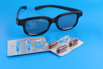 Vitamin complex capsules to improve vision and glasses. Prevention and treatment of eye diseases.