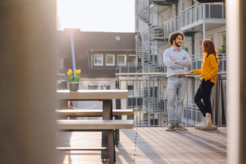 Two colleagues talking on roof terrace