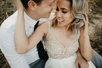 Affectionate bride and groom hugging outdoors