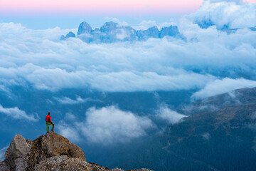 Italy, Veneto, Dolomites, Alta Via Bepi Zac, mountaineer standing on Pale di San Martino mountain...