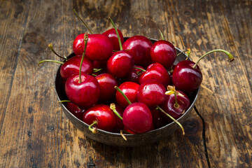 Bowl of cherries on wood