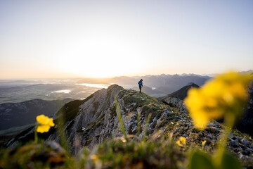 Hiker on viewpoint during sunrise, Brentenjoch, Bavaria, Germany