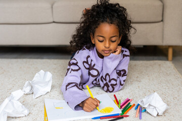 POC girl concentrated concentrated drawing with crayons 