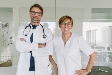 Portrait of confident doctor and assistant in medical practice