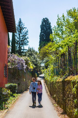 Fototapeta na wymiar Affectionate couple strolling through narrow alleys in Florence, Tuscany, Italy