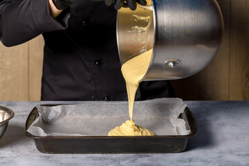 The process of making a roll. The pastry chef fills the baking tray with the ready dough for making the roll