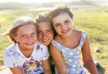 Group picture of three girls head to head in summer