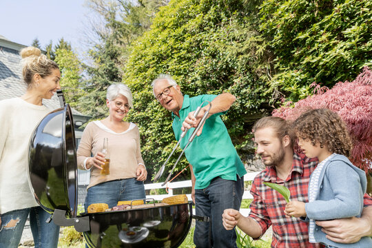 Extended family having a barbecue in garden