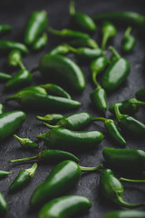 Green Jalapeno Peppers on Dark Concrete Backdrop