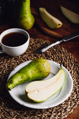 Halved Conference Pear on Plate and Cup of Coffee