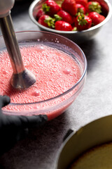 Beat strawberries with sugar in a blender. Close up